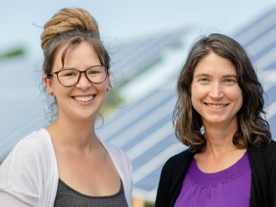 Chelsea Schelly (left) and Richelle Winkler (right) in front of a solar panel field